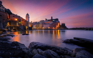 Cityscape water lake bridge tower - a clock tower in the distance free wallpaper
