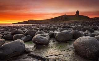 Rocky beach castle sunset mountains - a castle in the background free wallpaper