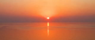 Sunset boat surfboard orange sky - a surfboard in the foreground free wallpaper