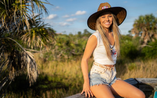 Woman hat sitting grass outdoors - syd meade free wallpaper