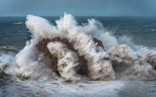 Large wave crash over rock - a large wave free wallpaper
