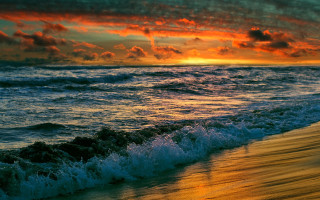 Sunset ocean waves beach surfer - a sunset over the ocean free wallpaper