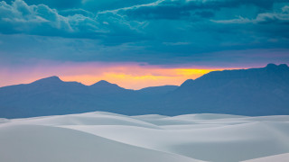 Sunset mountain range clouds landscape - a sunset over a mountain range free wallpaper
