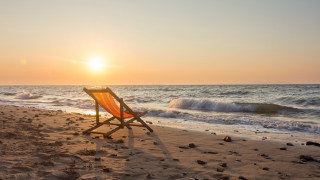 Beach chair sunset ocean sand - a beach chair free wallpaper