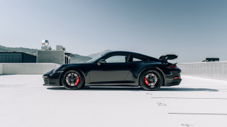 Black sports car parking lot 25 - a mountain in the background and a sky background free wallpaper