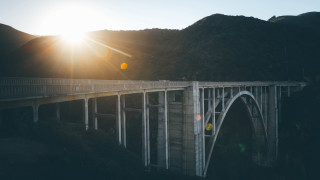 Bridge mountain sunset lens flare - a mountain in the foreground free wallpaper