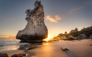 Beach sunset rock formation sand - a surfboard free wallpaper