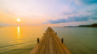 Dusk dock ocean boat sky - a boat in the distance free wallpaper
