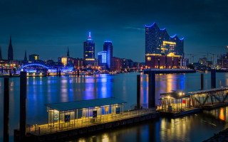 City skyline dock lit buildings - the building and the water free wallpaper