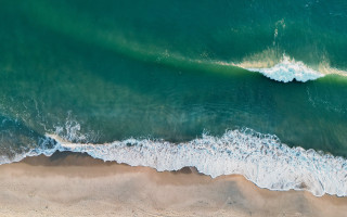 Beach wave surfboard ocean night - a view of a beach free wallpaper