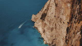 Boat cliff water cinematic photorealism - exekia free wallpaper