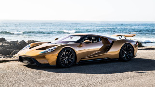 Gold sports car beach ocean - side profile free wallpaper