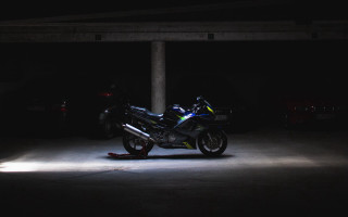 Motorcycle parking garage night minimalist - moody free wallpaper