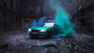 Green car blue smoke dirty - a building in the background free wallpaper