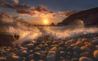 Sunset rocky beach waves formation 2 - a sunset over a rocky beach free wallpaper