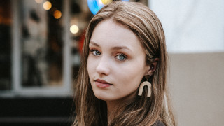 Woman longhair earrings serious look - product photo free wallpaper