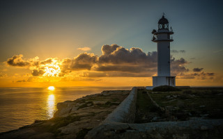 Lighthouse rocky cliff sunset clouds 2 - a rocky cliff free wallpaper