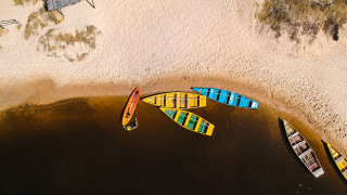 Canoes shore lake summer vibrant - a sandy beach free wallpaper