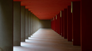 Red hallway symmetric doors columns - symmetric free wallpaper