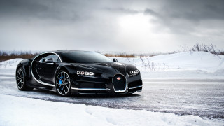 Bugatti snowy road mountain vehicle - a dark sky in the background free wallpaper