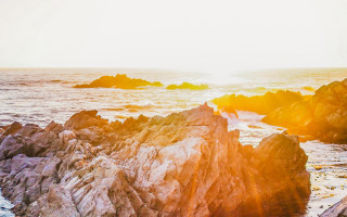 Rocky beach surfboard sunset ocean - a surfboard free wallpaper