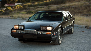 Black car gravel road hill - a black car free wallpaper