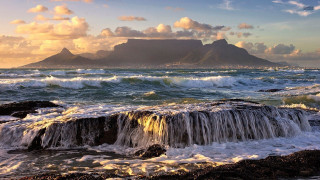Mountain lake waves clouds sunset - a mountain in the distance free wallpaper