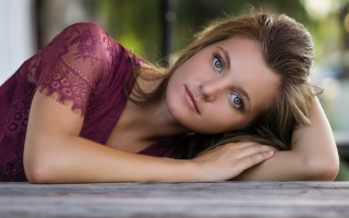 Purple dress woman laying portrait - a wooden table free wallpaper