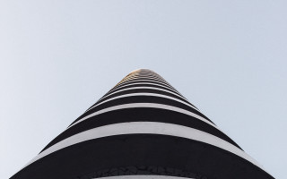 Tall building clock abstract sculpture - bold free wallpaper