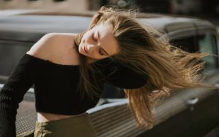 Woman blowing hair bench car - a car in the background free wallpaper