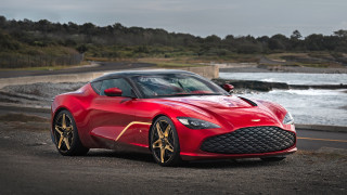 Red sports car parked water - near free wallpaper
