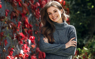 Woman smiling crossed arms christmas - red flower free wallpaper