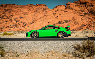 Green sports car mountain red - a road in front free wallpaper