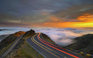 Mountain road cars sunset horizon - a sunset in the background free wallpaper