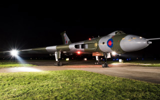 Military jet night runway lights - a green grass area free wallpaper