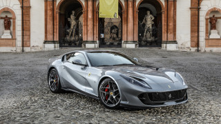 Silver sports car building statue - a statue of a man free wallpaper