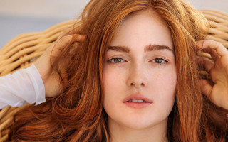 Freckled hair woman holding head - hair free wallpaper