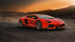 Red sports car sunset mountains - a parking lot free wallpaper