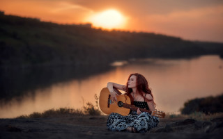 Woman sitting guitar sunset beach - a guitar free wallpaper