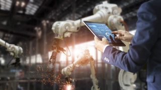 Factory robots man laptop blurry - free technology wallpaper