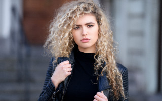 Curly haired woman black jacket - outside free wallpaper