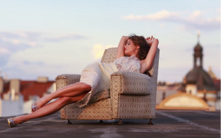 Woman sitting beach city bokeh - a city in the background free wallpaper