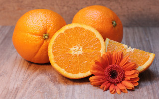 Orange flower slice on table - wooden free wallpaper