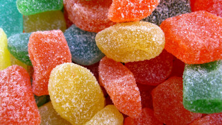 Gummy bears blue background yellow - a close up of a pile free wallpaper