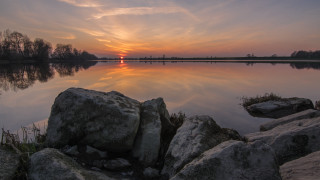 Sunset lake rocks grass mountain 2 - a sunset over a lake free wallpaper