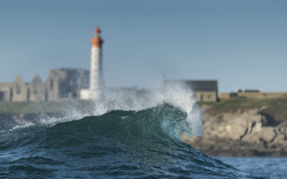 Lighthouse wave ocean beach scenery - a lighthouse free wallpaper