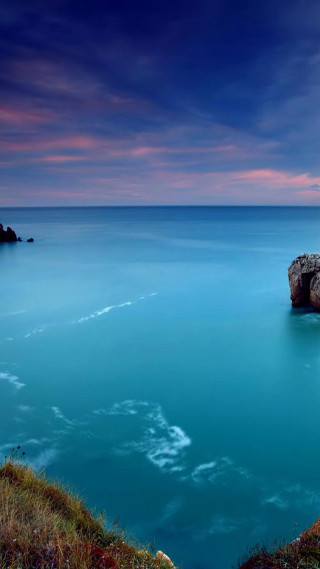 Large rock ocean cliff sunset - a sunset in the background free wallpaper