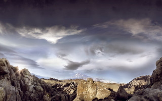 Mountain landscape rocks cloudy sky - a mountain range in the distance free wallpaper