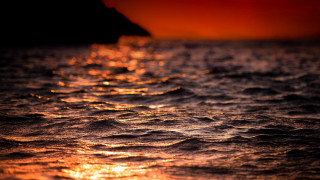 Sunset ocean boat red sky - a boat in the distance free wallpaper