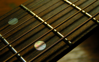 Guitar neck blurry frets baroque - a close up of a guitar neck free wallpaper
